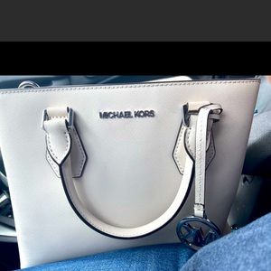 White worn Michael Kors purse.